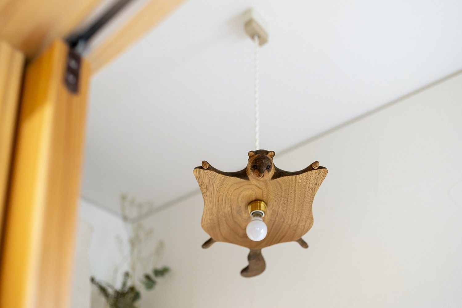 トイレの照明は、印象的なムササビランプ（arts&crafts KIYATA）。殺風景になりがちな空間にこそ、思い切った遊び心をプラスするのもGood。